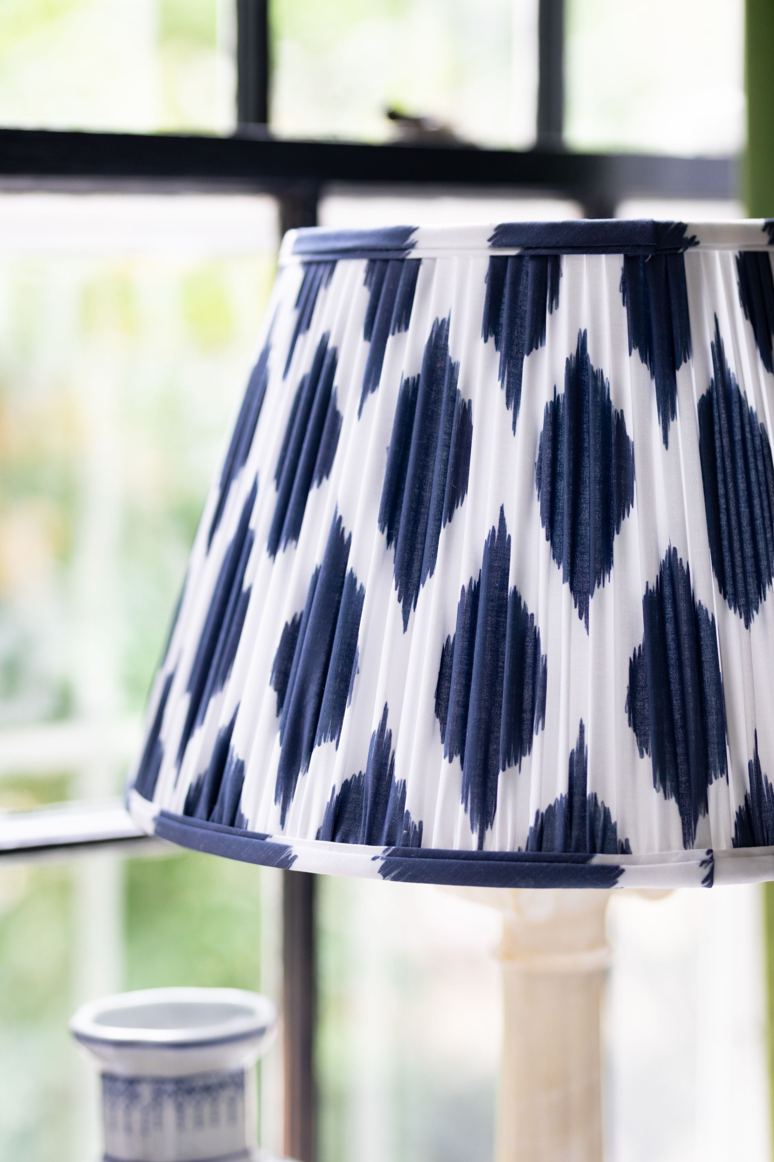 Close up of the detail on a navy blue and white lamp shade.